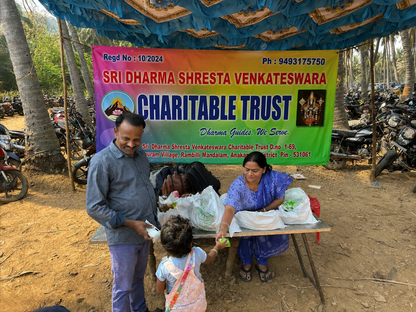Trust members are distributing water and butter milk to people. Conducted in Upamaaka Temple.